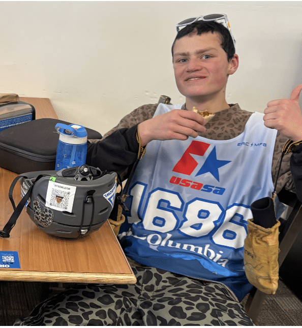 Tyler, Flagstaff Après Ski team member, smiling in a ski race bib